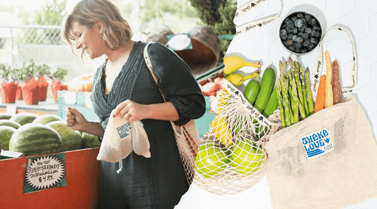 A woman shopping at a farmers market, using SHaka Love reusable mesh bags to carry her produce, demonstrating a commitment to eco-friendly bags and a plastic-free lifestyle