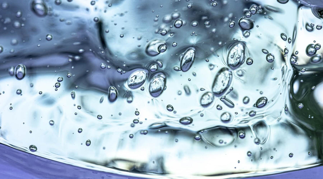 Close-up photo of small, translucent bubbles floating in clear water