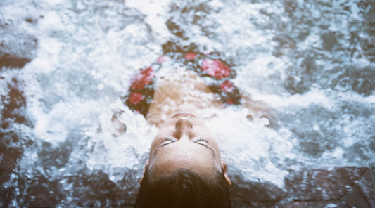 A woman relaxes in cold water, preparing to get into cold water swimming